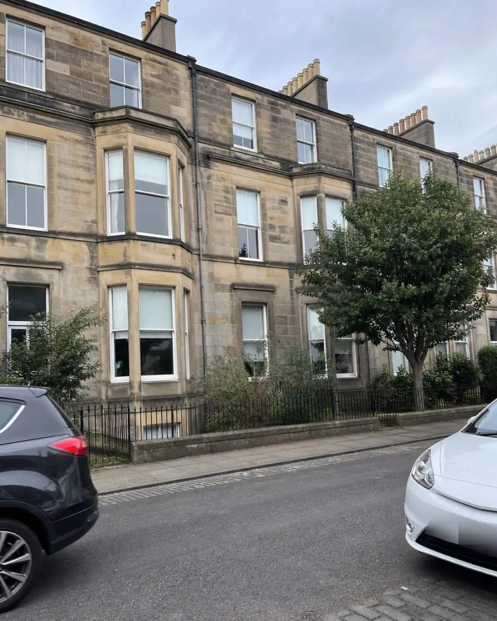 Stone tenement flats with bay windows on a Marchmont street