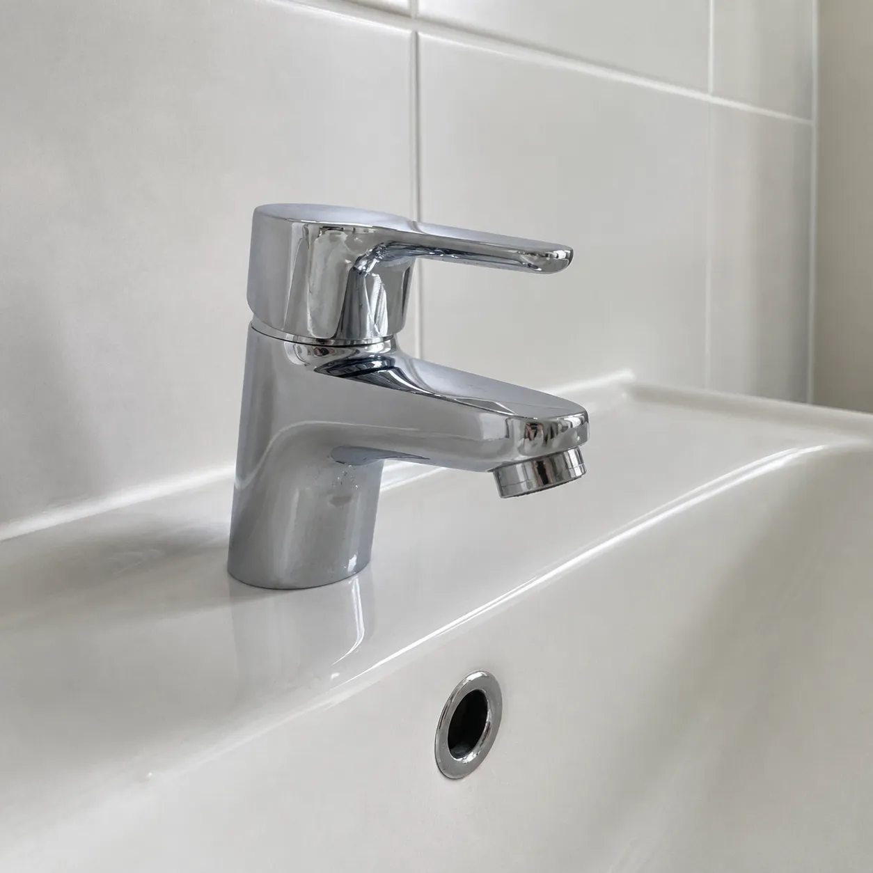 A polished chrome mixer tap on a clean white basin